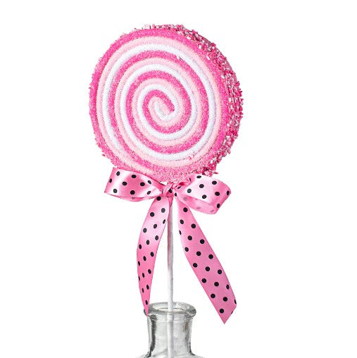 a pink and white lollipop on a stick