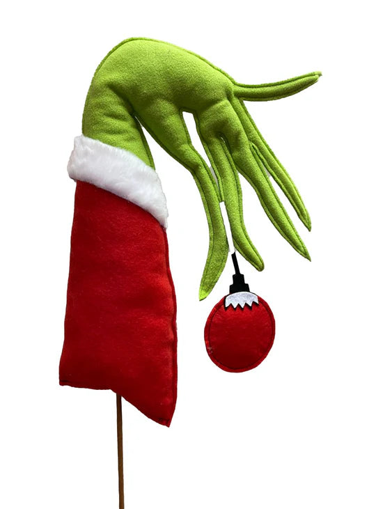 a hand that is holding a christmas ornament