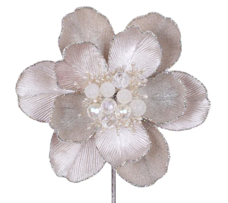 A close-up image of a decorative flower with a large center bloom surrounded by smaller petals.