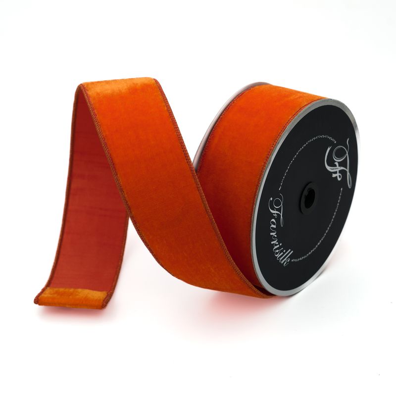 a roll of orange satin ribbon on a white background
