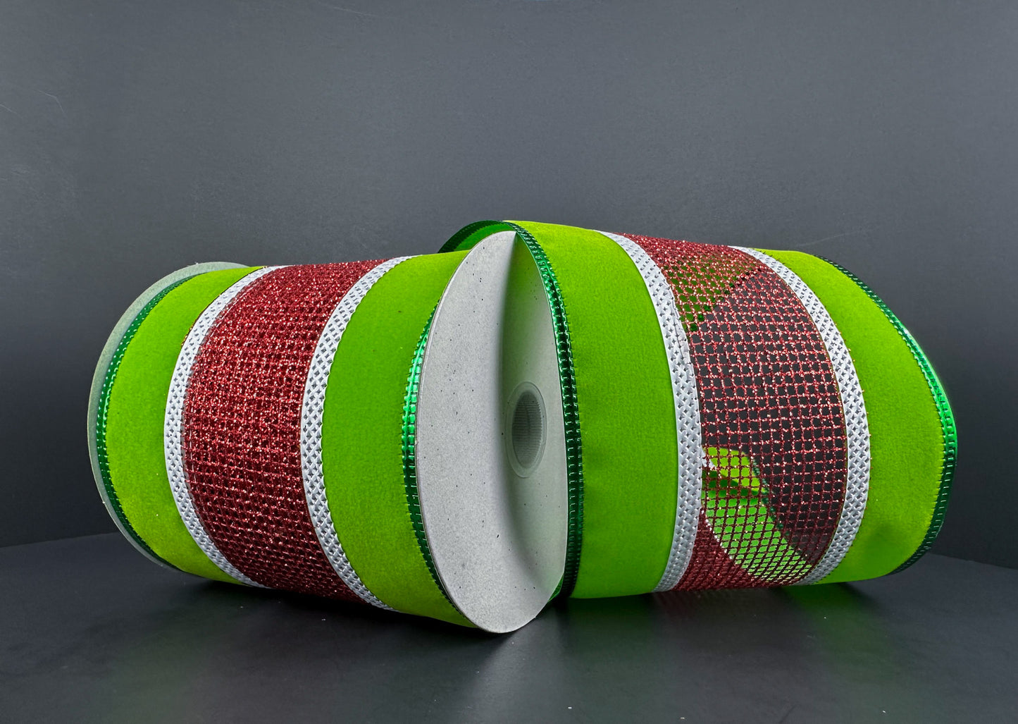 a roll of green and red ribbon on a table