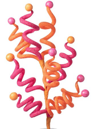 a pink and orange cake topper sitting on top of a table