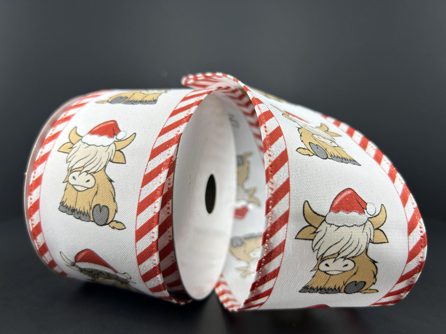 a roll of red and white christmas ribbon on a table
