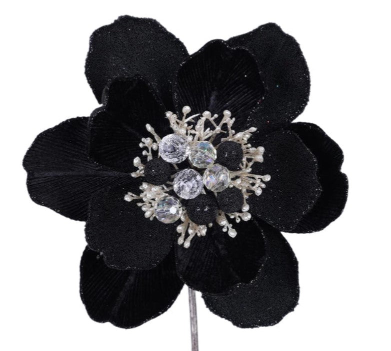 A close-up image of a black flower with a sparkling crystal center.