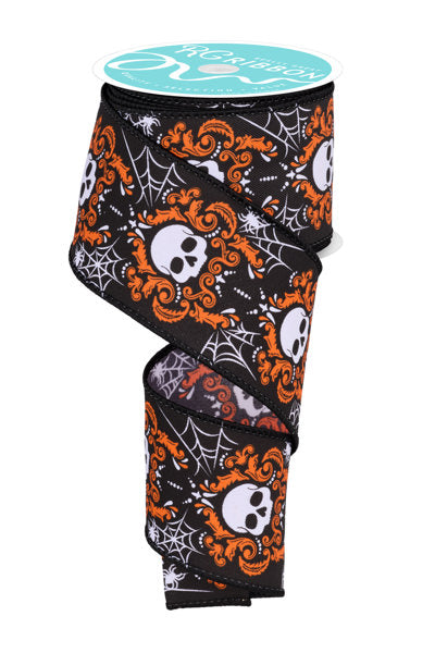 a roll of halloween ribbon with skulls and spider webs on it