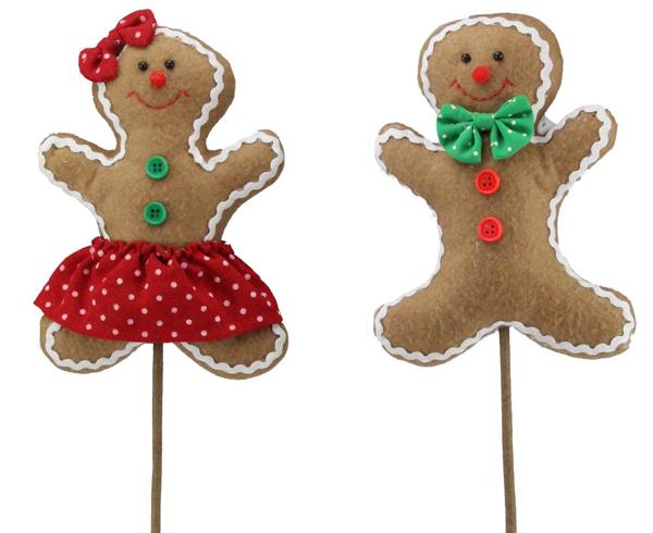 a pair of gingerbread man and woman on a stick