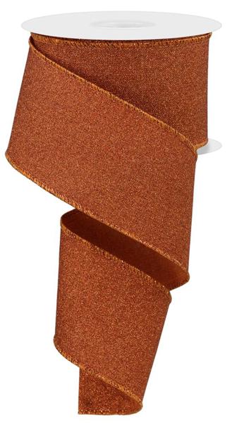 a roll of brown glitter ribbon on a white background