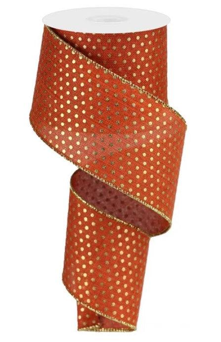 A roll of red and gold polka dot ribbon.