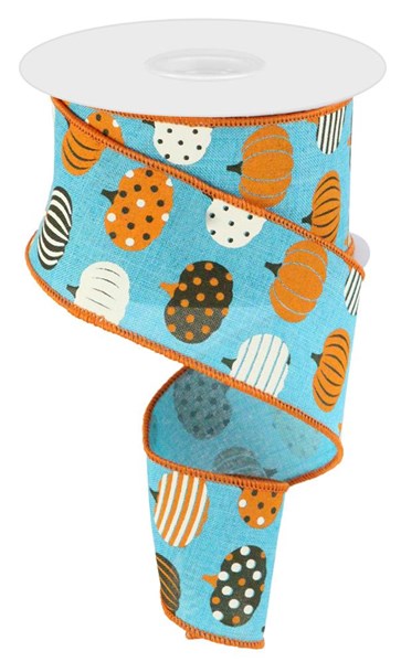 a roll of blue ribbon with orange and white pumpkins on it