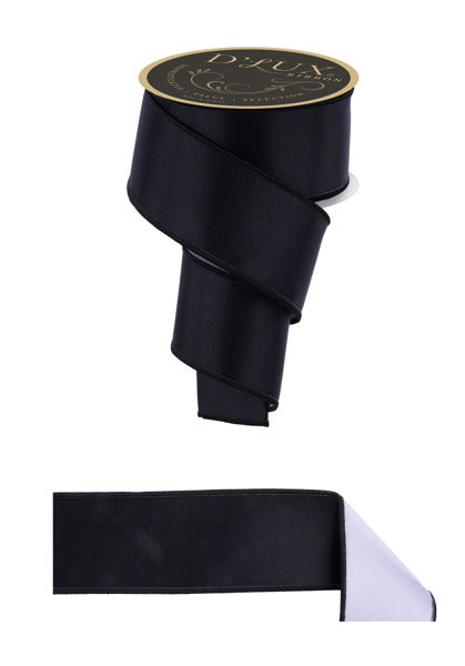 a roll of black satin ribbon on a white background