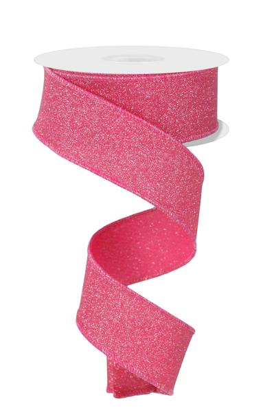 a roll of pink glitter ribbon on a white background