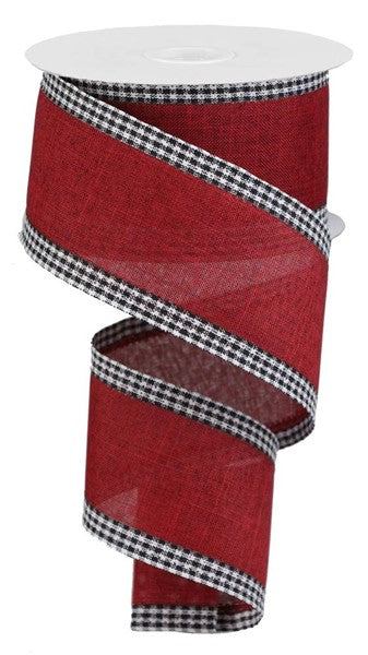 a roll of red and black checkered ribbon