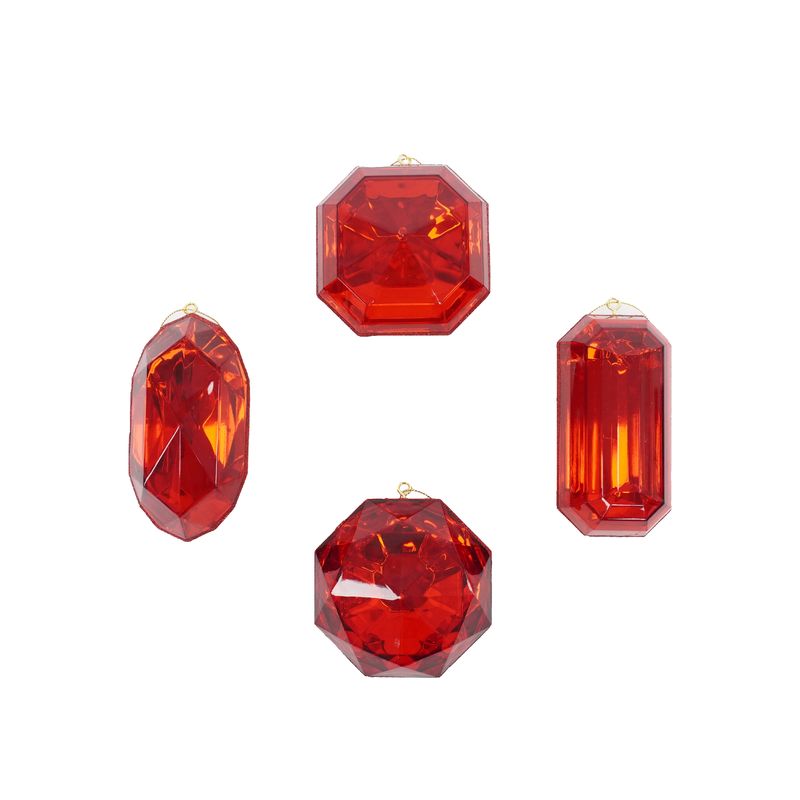 a group of three red jeweled objects on a white background