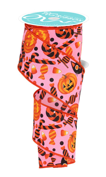 a spool of pink halloween ribbon with pumpkins and jack - o - lanterns
