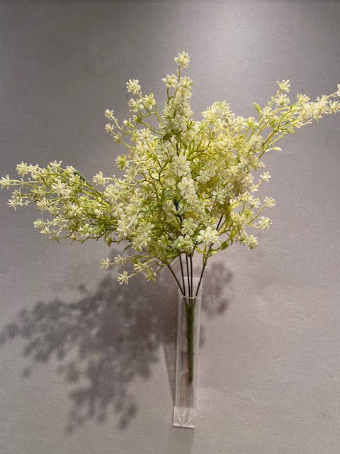a vase filled with white flowers on top of a table