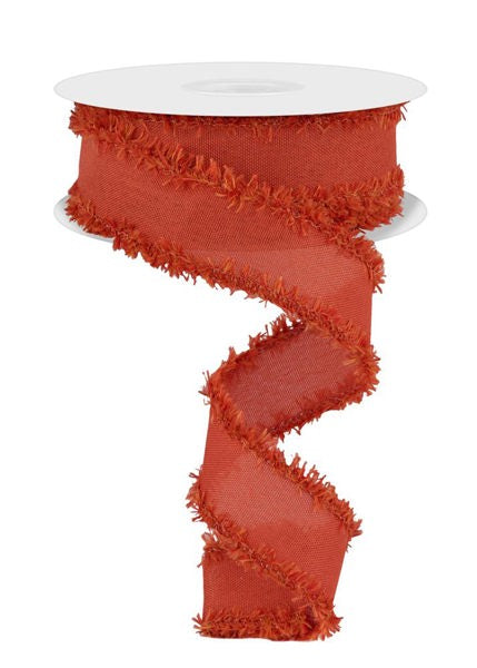 a red, fringed ribbon with a white base, which appears to be a decorative item.