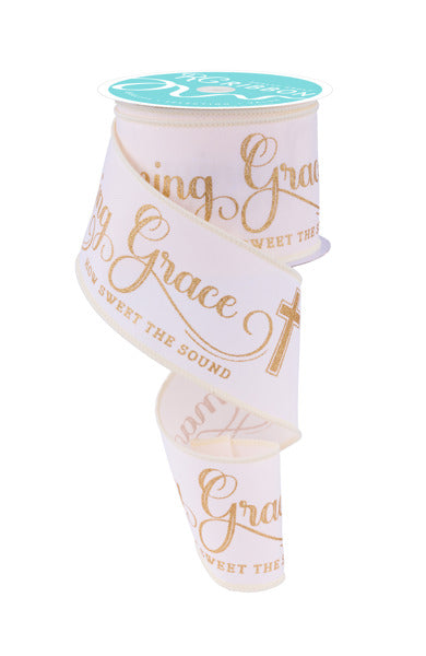 a roll of white ribbon with gold lettering