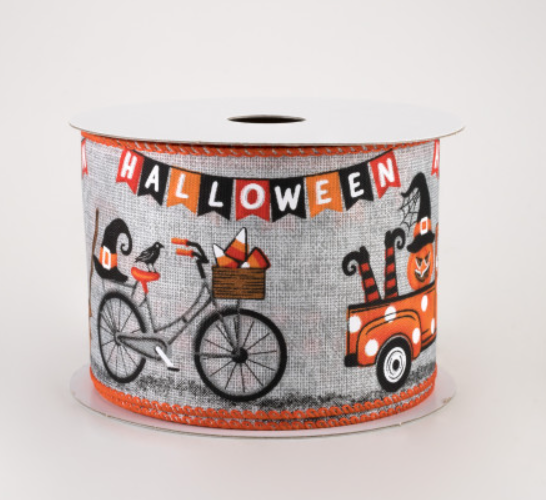 a roll of halloween tape with a bike and cat on it
