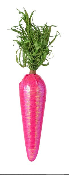 a pink vase with a green plant in it