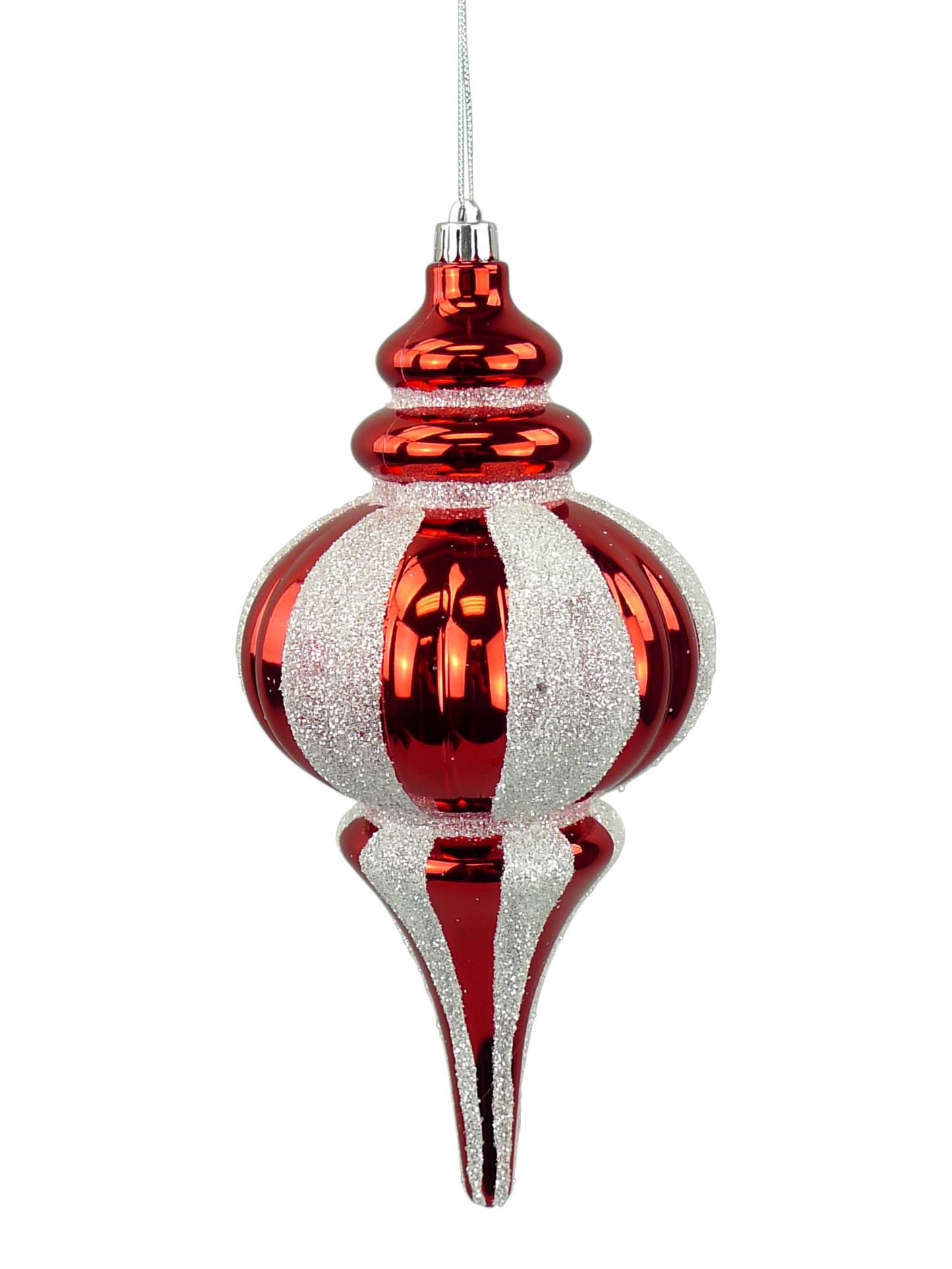 A red and white striped ornament with a pointed top and a long, thin body is suspended from a string.