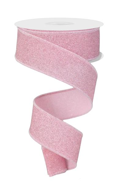 a roll of pink glitter ribbon on a white background