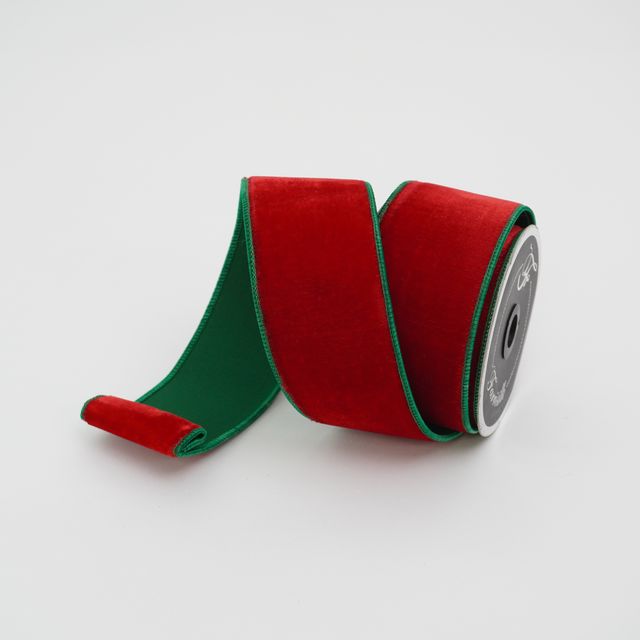 a roll of red and green ribbon on a white background