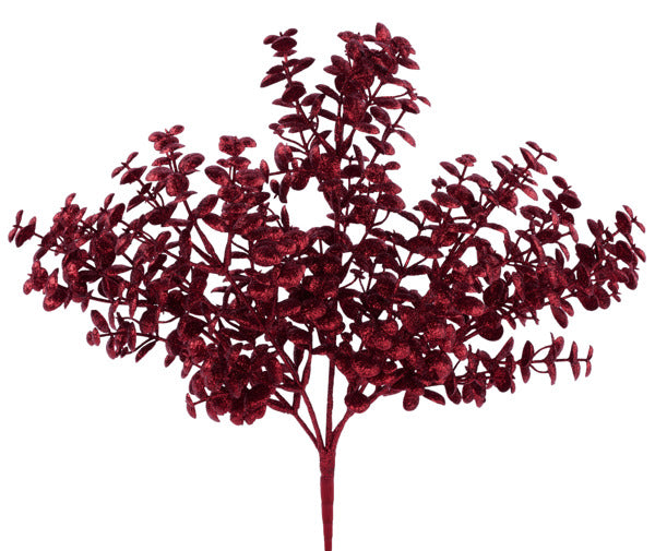 A branch with red leaves and flowers against a white background.