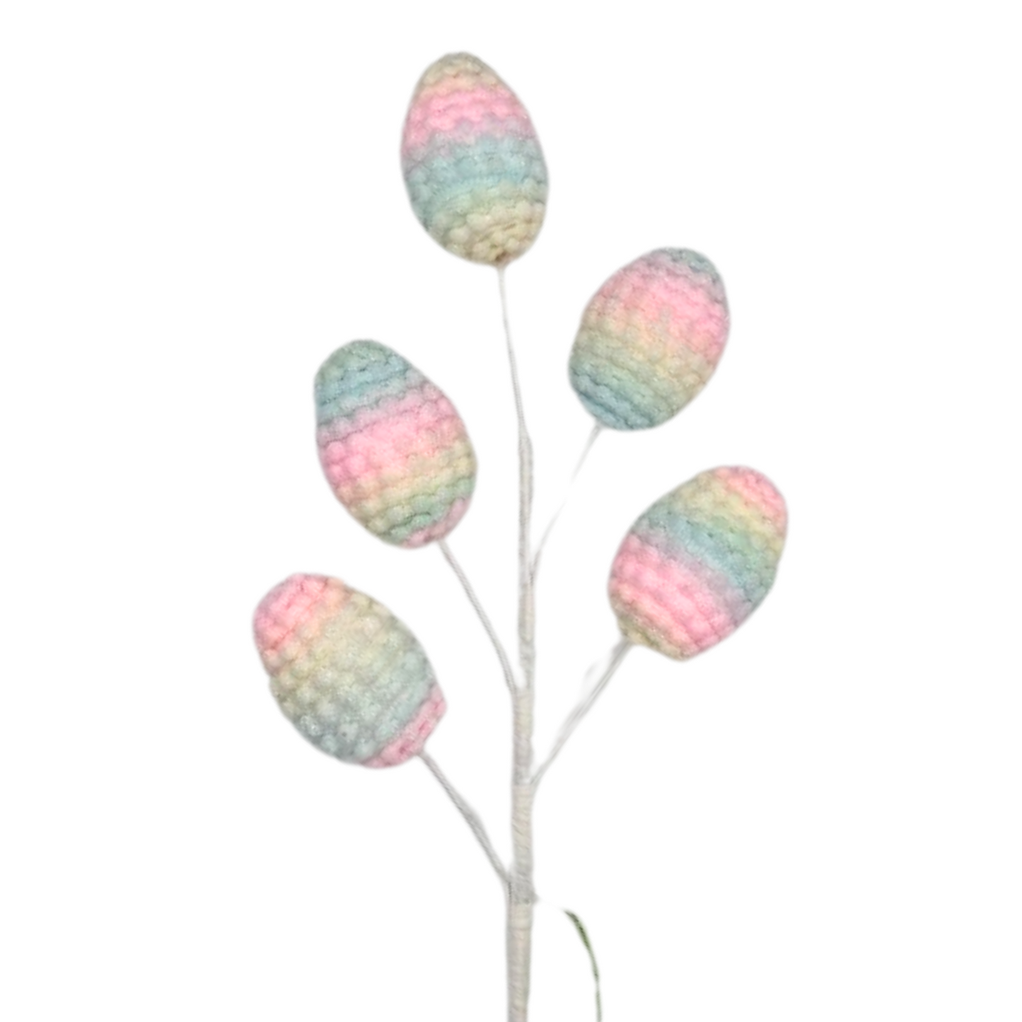 a crocheted plant with four eggs on it
