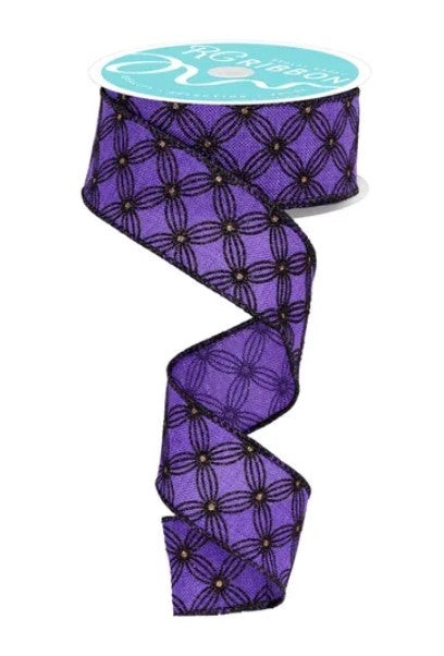 a purple and black patterned ribbon with a turquoise label.