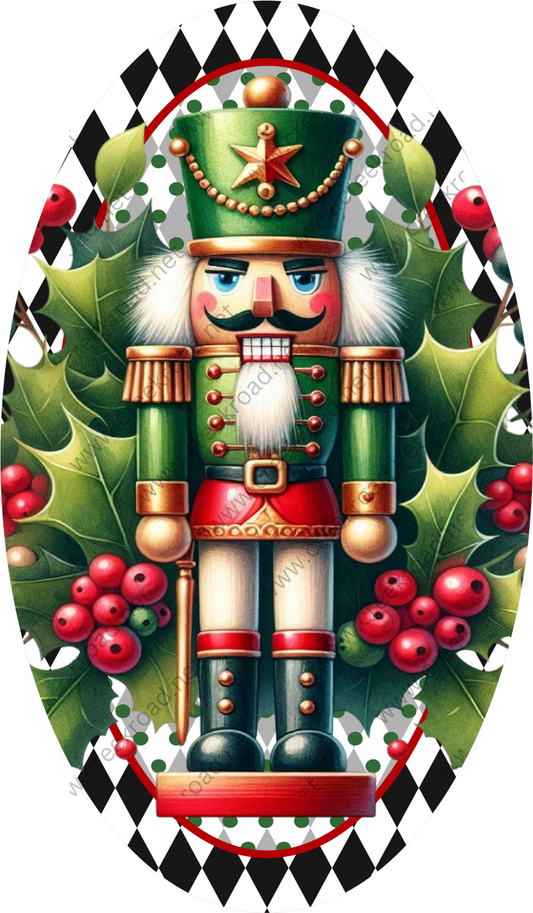 A nutcracker figure wearing a green hat and red boots, surrounded by holly leaves and red berries, is the central focus of the image.
