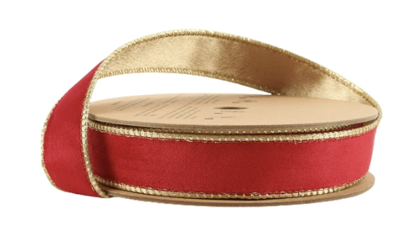 A close-up image of a red and gold ribbon spool with a gold-colored spool.