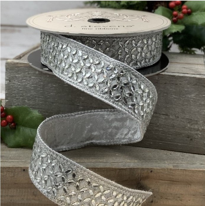 a roll of silver ribbon on a wooden box