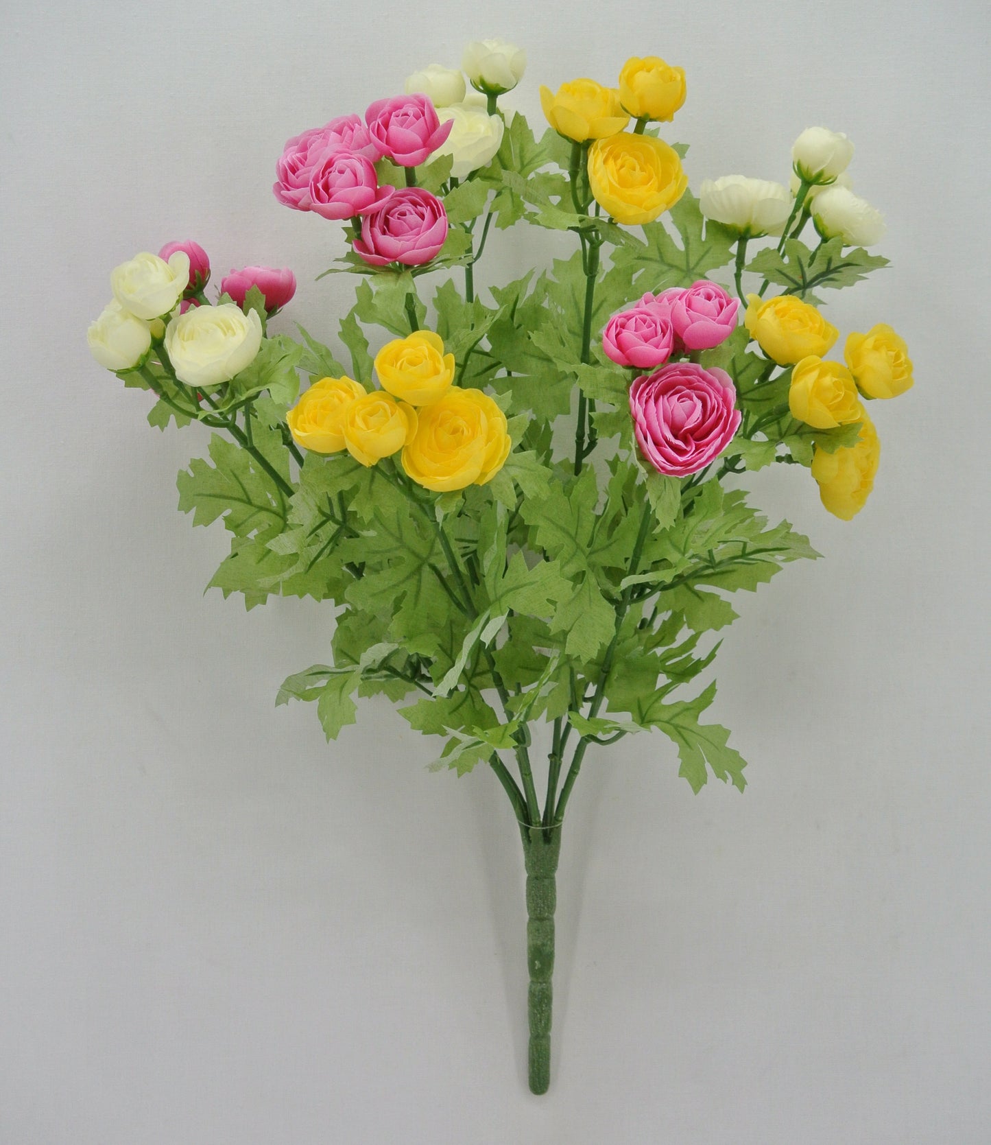 A bouquet of colorful artificial flowers, including pink, yellow, and white roses, arranged in a lush green stem.