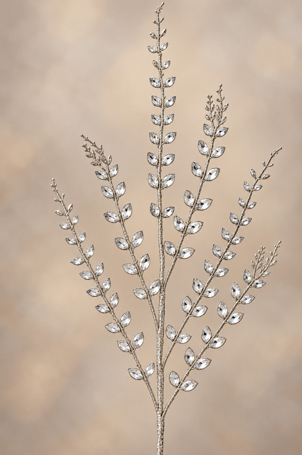 A decorative branch made of small, clear glass or crystal elements, creating a sparkling, elegant appearance.
