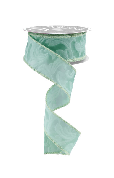 a roll of light green satin ribbon on a white background