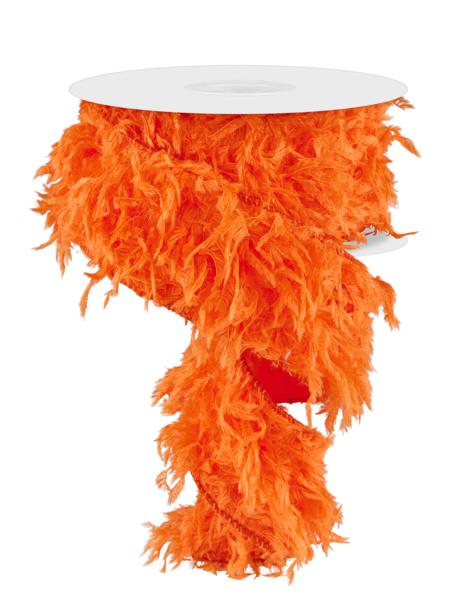 a round table topped with an orange feathered tablecloth