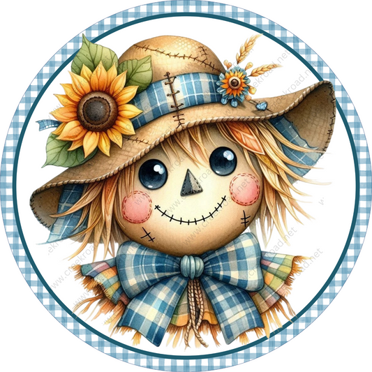 A cheerful scarecrow with a sunflower hat, plaid scarf, and bow, set against a blue and white checkered background.