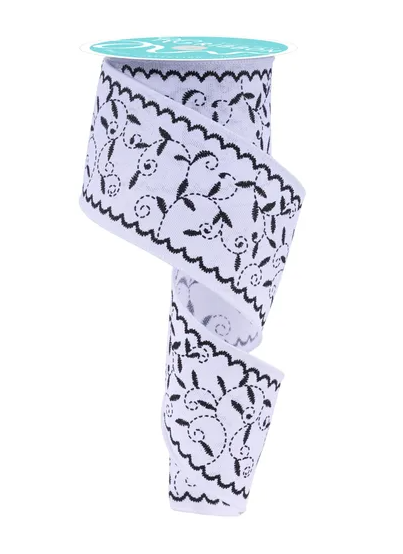 A roll of decorative ribbon with a floral pattern on it.