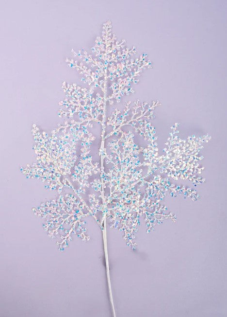 A delicate, white branch adorned with small, multicolored flowers or berries against a soft purple background.