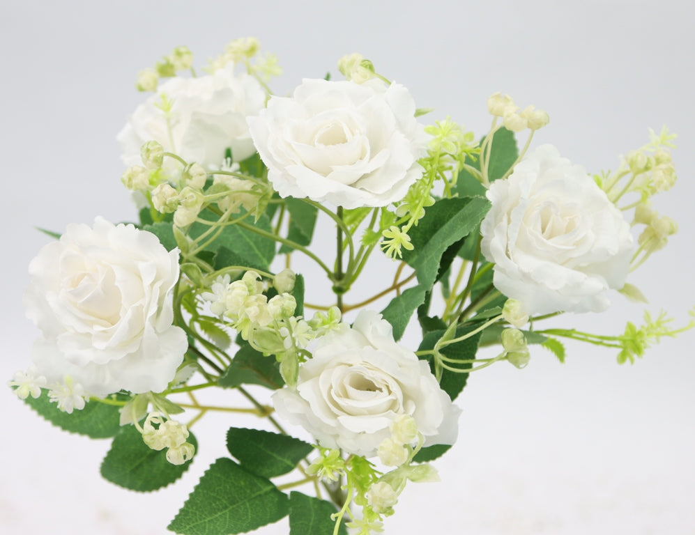 a vase filled with white flowers on top of a table