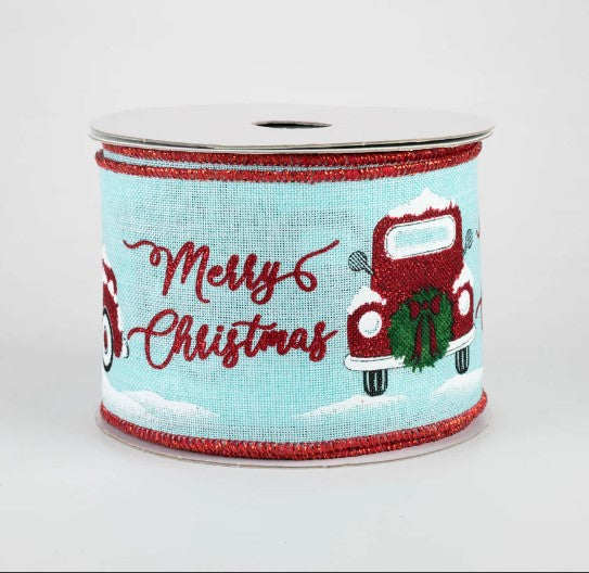 a roll of christmas ribbon with a red truck on it