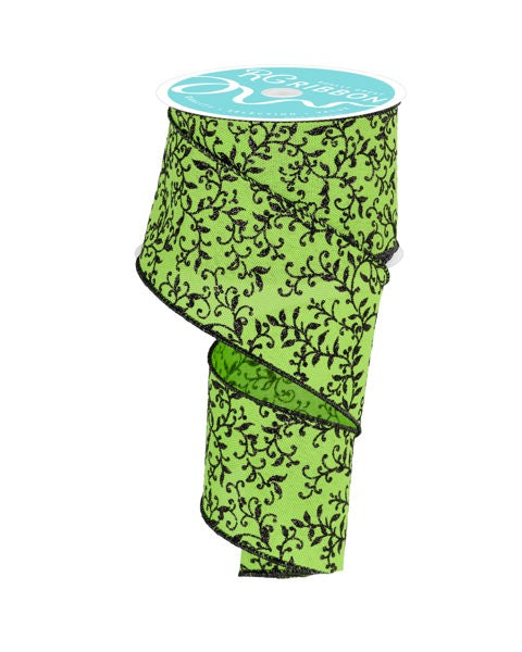 a roll of green fabric with black flowers on it