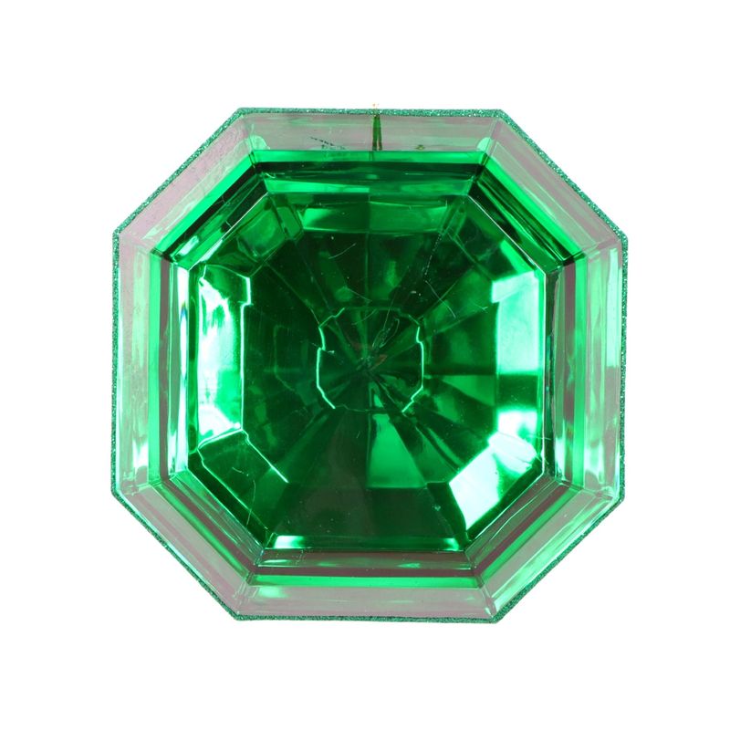 a close up of a green diamond on a white background