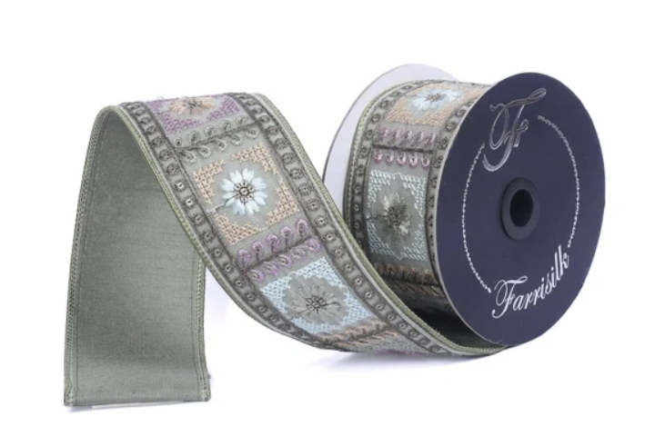 A roll of decorative fabric ribbon with a floral pattern, featuring a dark blue background and a white label with the text "Farnivals" printed on it.