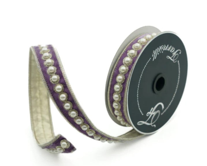 a purple and white ribbon with pearls on it