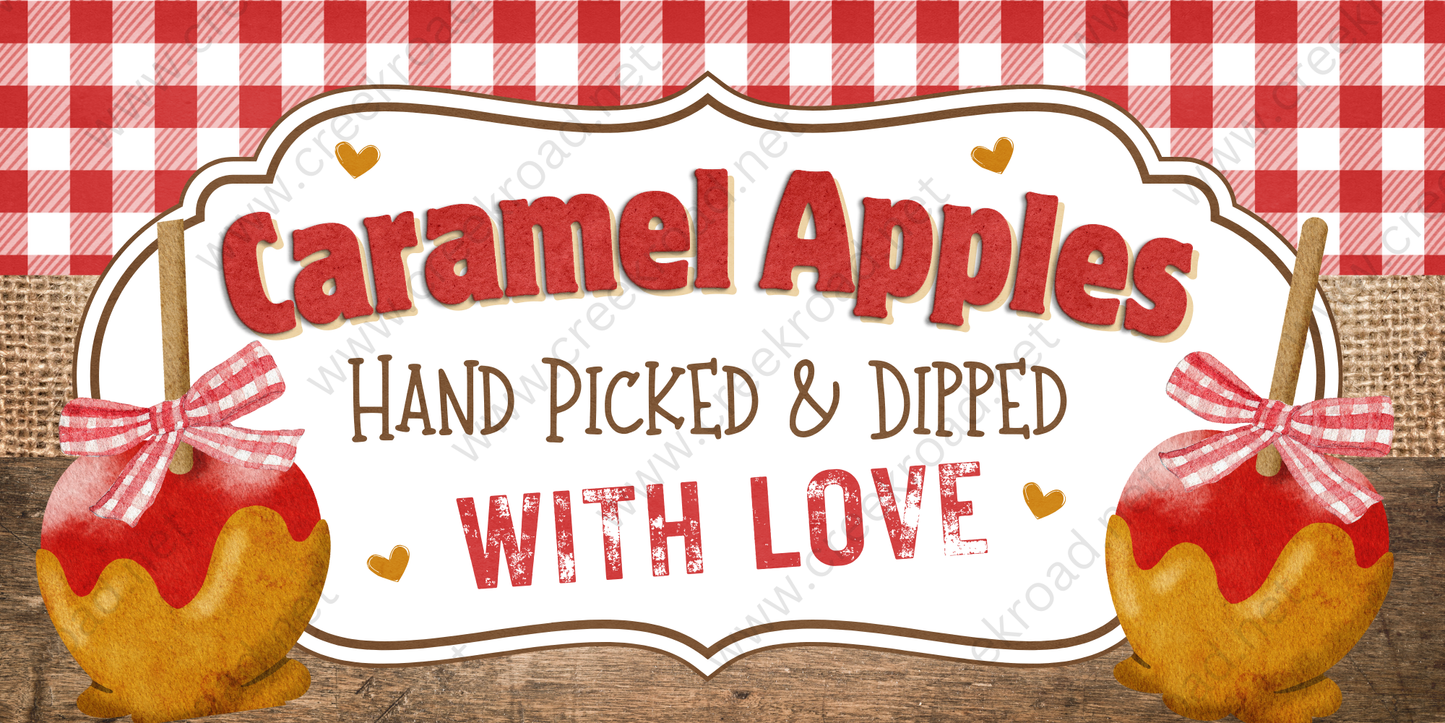 a sign for "Caramel Apples" that reads "Hand Picked & Dipped with Love". The sign is set against a red and white checkered background, and there are two caramel apples on either side of the sign, each with a red ribbon tied around it.