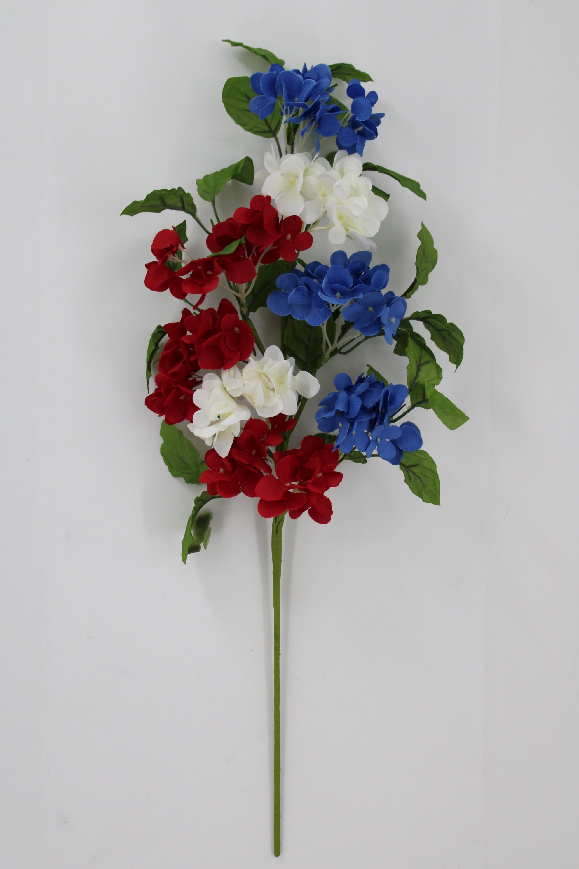 A bouquet of red, white, and blue flowers is displayed against a white background.