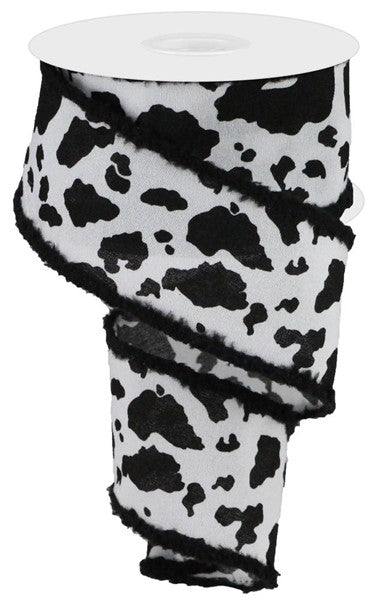 a roll of toilet paper with black and white spots
