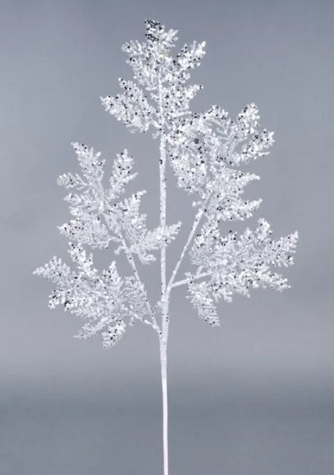 A white, snowflake-like branch with intricate, sparkling details stands out against a gray background.