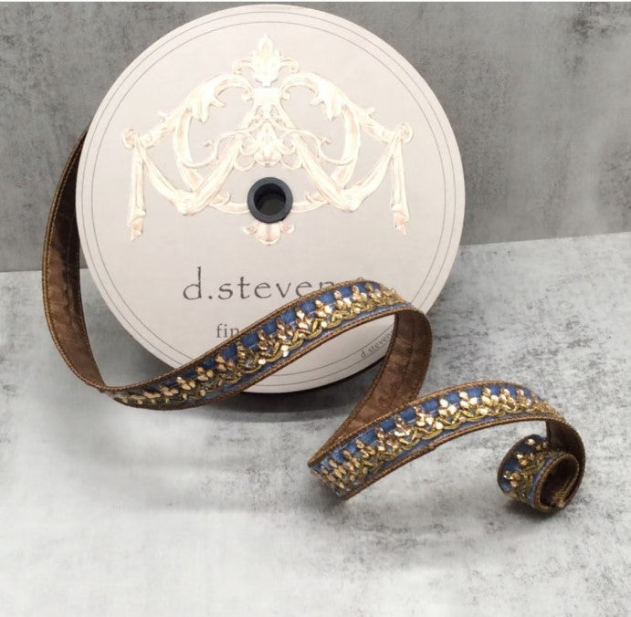 a pair of gold and blue ribbon with a crown on it